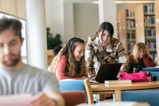 Student Friends Working Together On Laptop