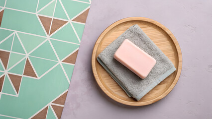 Pink Bar Soap on Gray Towel in Wooden Bowl