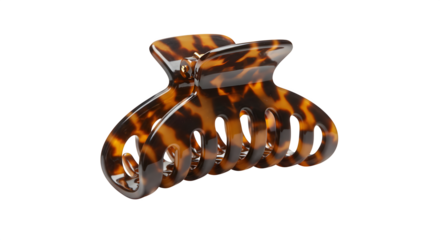 Brown tortoiseshell claw clip gleams on black. Styling accessory. Perfect for e-commerce, product catalogs, and fashion ads.