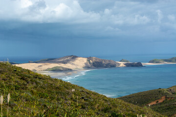 Scenic Coastal View with Sandy Beach and Lush Hills