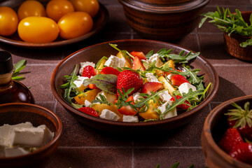 Delicious summer salad with strawberries, yellow tomatoes, and feta cheese