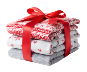 Holiday gift of folded sweaters tied with a festive red ribbon, ready to give