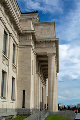Fototapeta premium Grand Architectural Building with Columns Against Blue Sky
