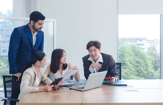 Business manager employee teamwork asian group meeting presentation look holding document computer on desk labtop talk project creative plan ready for happy work marketing online sale in room office