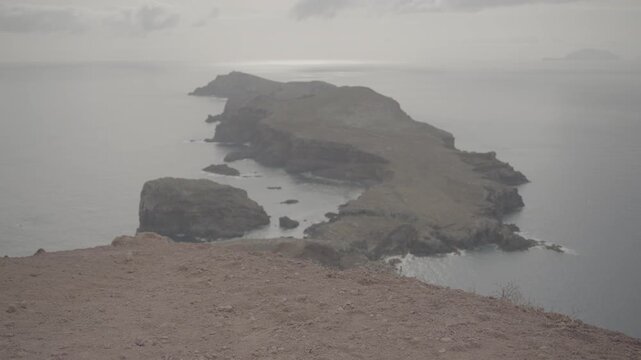 Dusty foreground with layered coastal cliffs in wide shot from Madeira, Portugal (SLOG3)