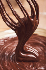 a bowl of chocolate dough, a whisk for whipping, baking, structure and consistency, homemade, top view, no people,