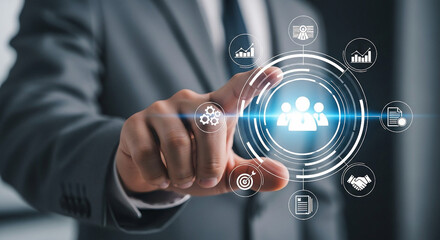 Man in suit touching digital interface with team and business icons technology