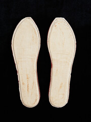 Pair of Fabric Shoe Insoles Against a Black Background