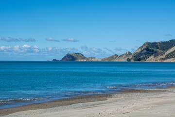 Serene Beach with Turquoise Waters and Distant Hills