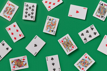 Playing cards spread on green felt surface