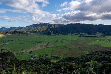 Lush Green Valley Surrounded by Mountains