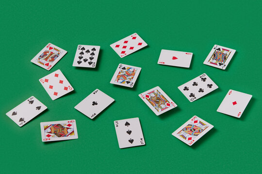 Scattered playing cards on green table