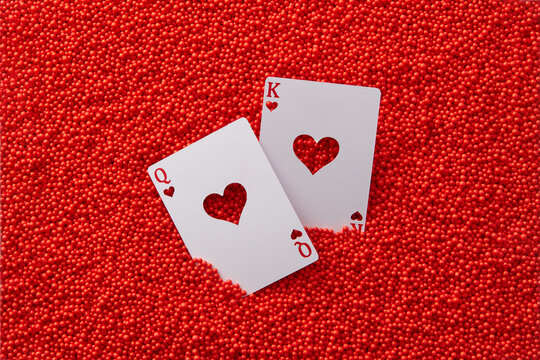Queen and king heart cards in red balls