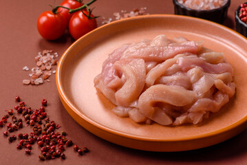 Raw chicken meat cut into strips, fresh fillet or breast slices. Chicken raw meat in pieces