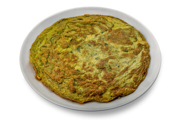Green omelet made with eggs and wild and aromatic herbs in plate isolated