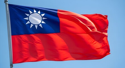 Naklejka premium Taiwanese Flag Waving Proudly Against Blue Sky