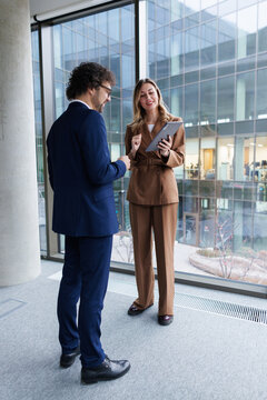 Business partners in suits brainstorming ideas for venture at office