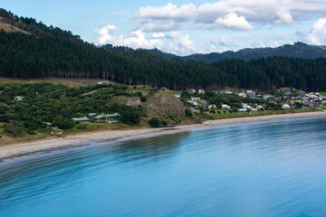 Serene Coastal Landscape with Calm Blue Sea and Lush Green Hills