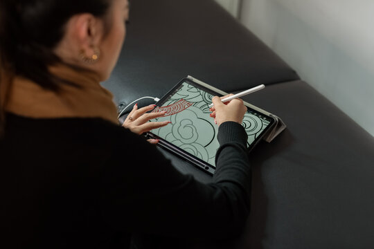 Woman drawing on tablet computer
