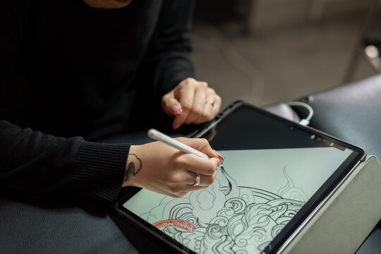 Anonymous artist designing tattoo