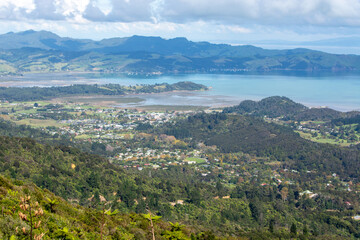 Fototapeta premium Panoramic Coastal View with Lush Green Hills