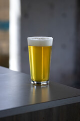 Glass of a perfectly pour beer on a table