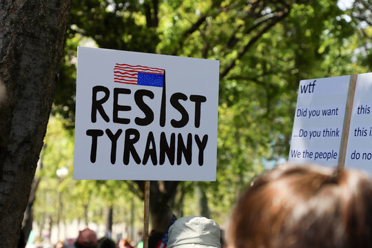 Signs from HANDS OFF protest