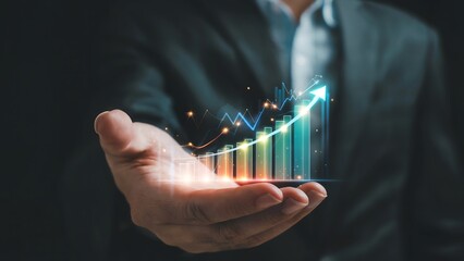 Businessman holding a glowing upward trending financial graph in his palm