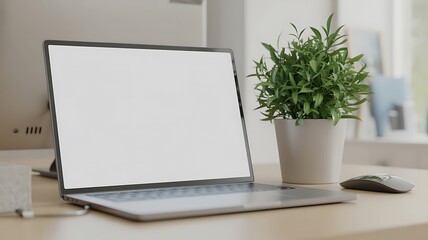 Fototapeta premium Modern laptop with blank screen and green plant on a desk