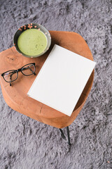 blank book cover mockup on coffee table with green matcha tea