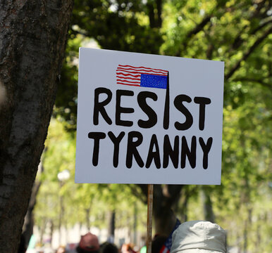 Signs from HANDS OFF protest