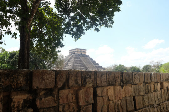 Chichen Itza Temple Behind Stone Wall and Tree