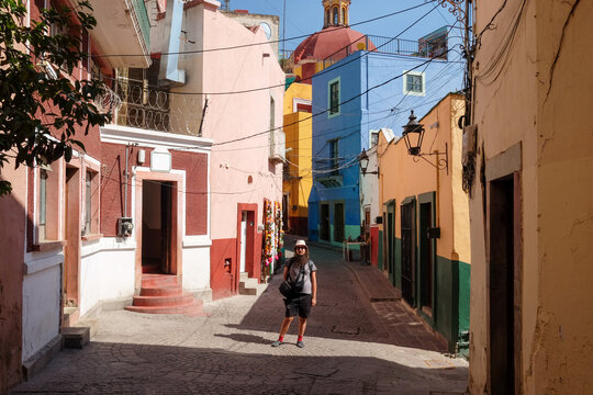 Man Walking Toward Colorful Alley