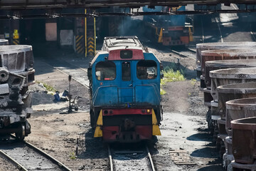 A diesel locomotive for industrial trolleys at steel mill.