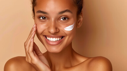 Beautiful woman applying moisturizer on her face, showcasing radiant skin and joyful expression. warm background enhances natural beauty and skincare routine