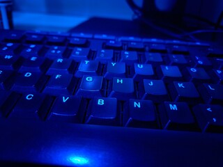 Close-up of a modern computer keyboard with sleek keys, ideal for illustrating digital workspaces,...