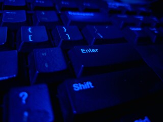 Close-up of a modern computer keyboard with sleek keys, ideal for illustrating digital workspaces,...