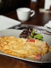 Fresh Omelette with Tomatoes and Salad on Plate