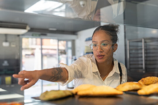 Woman choosing snacks in bakery