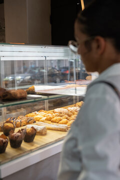 Woman looking at pastry display case