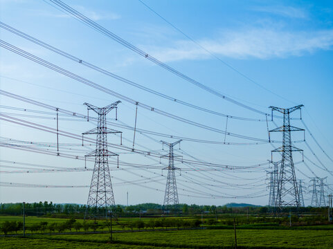 Aerial View of High Voltage Transmission Towers Standing in Fields