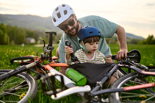 A father and his child explore a bike components