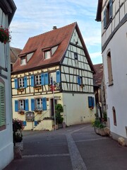 narrow street in the old town of Riquewihr, Alsace, France