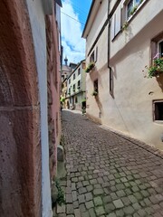narrow street in the old town of Riquewihr, Alsace, France