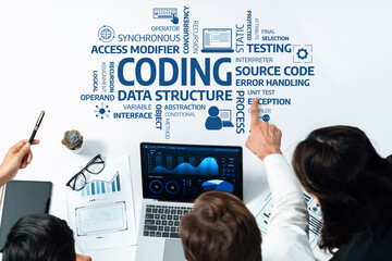 A professional team analyzing coding concepts, including data structure and process flow, in a modern workspace with charts and technology tools for effective collaboration. Amity