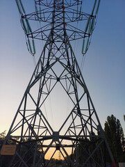High Voltage Power Transmission Tower Silhouette at Sunset