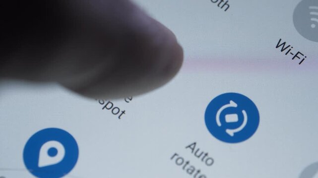 Toggling the various settings icon on a smartphone display like dark mode Wi-Fi toggle or mobile data 
