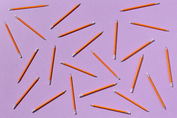 Orange pencils on violet background