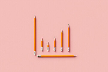 Pencils arranged as graph on pink background