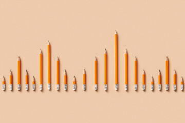 Top view of orange pencils forming chart bars